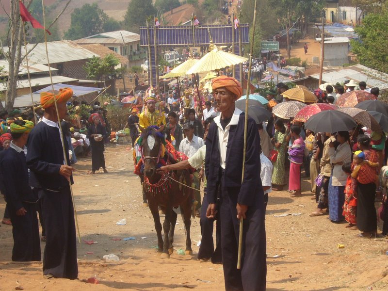 Novices on horseback follow.